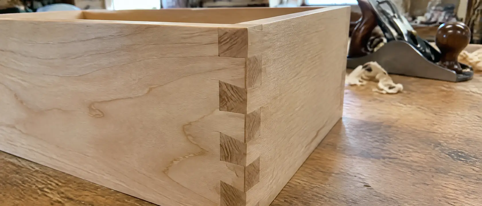 A dovetailed drawer corner in solid maple with pins and tails flush
