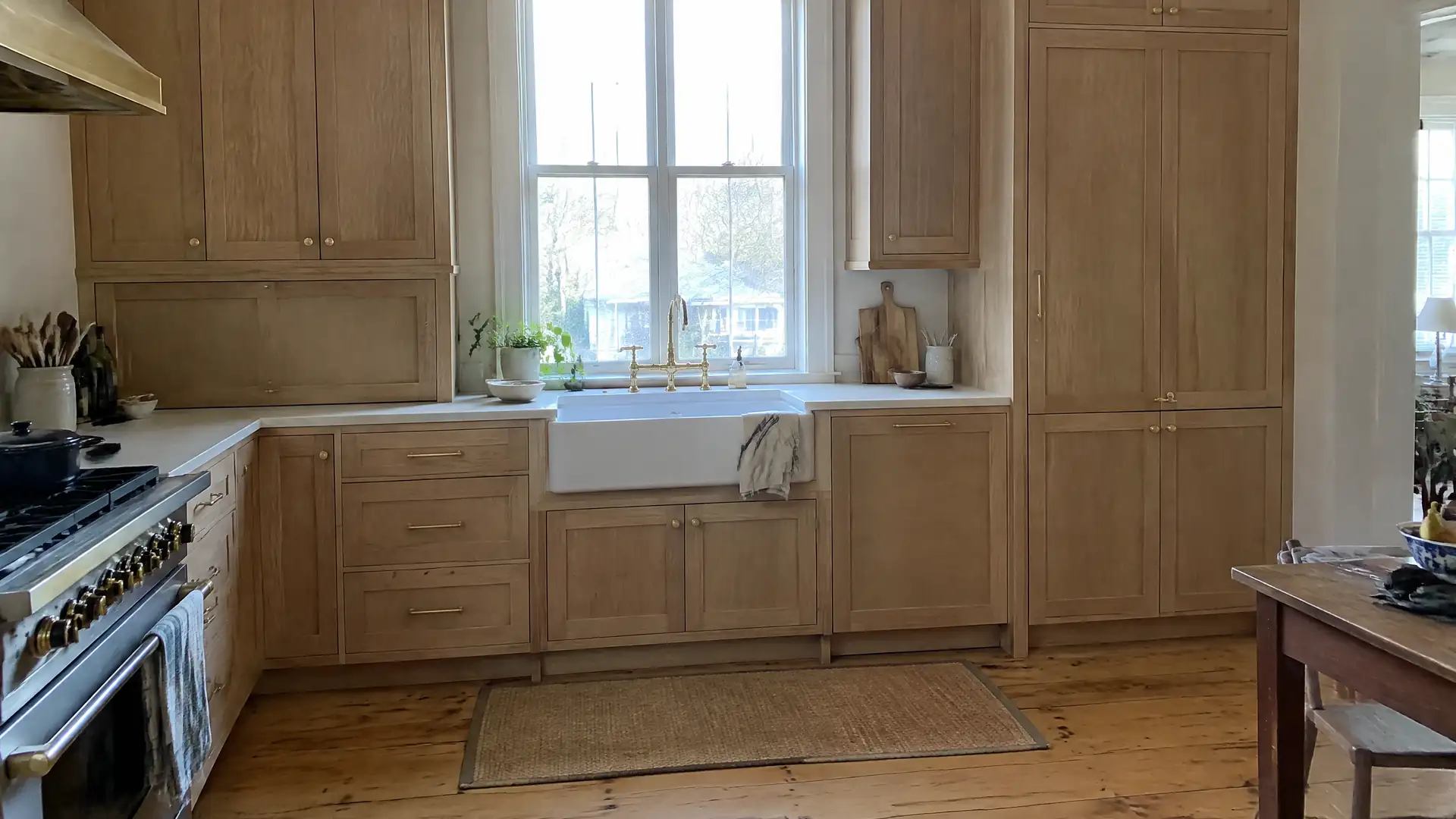 Full-height rift-cut white oak cabinetry with inset doors scribed to an out-of-square wall in Lynn