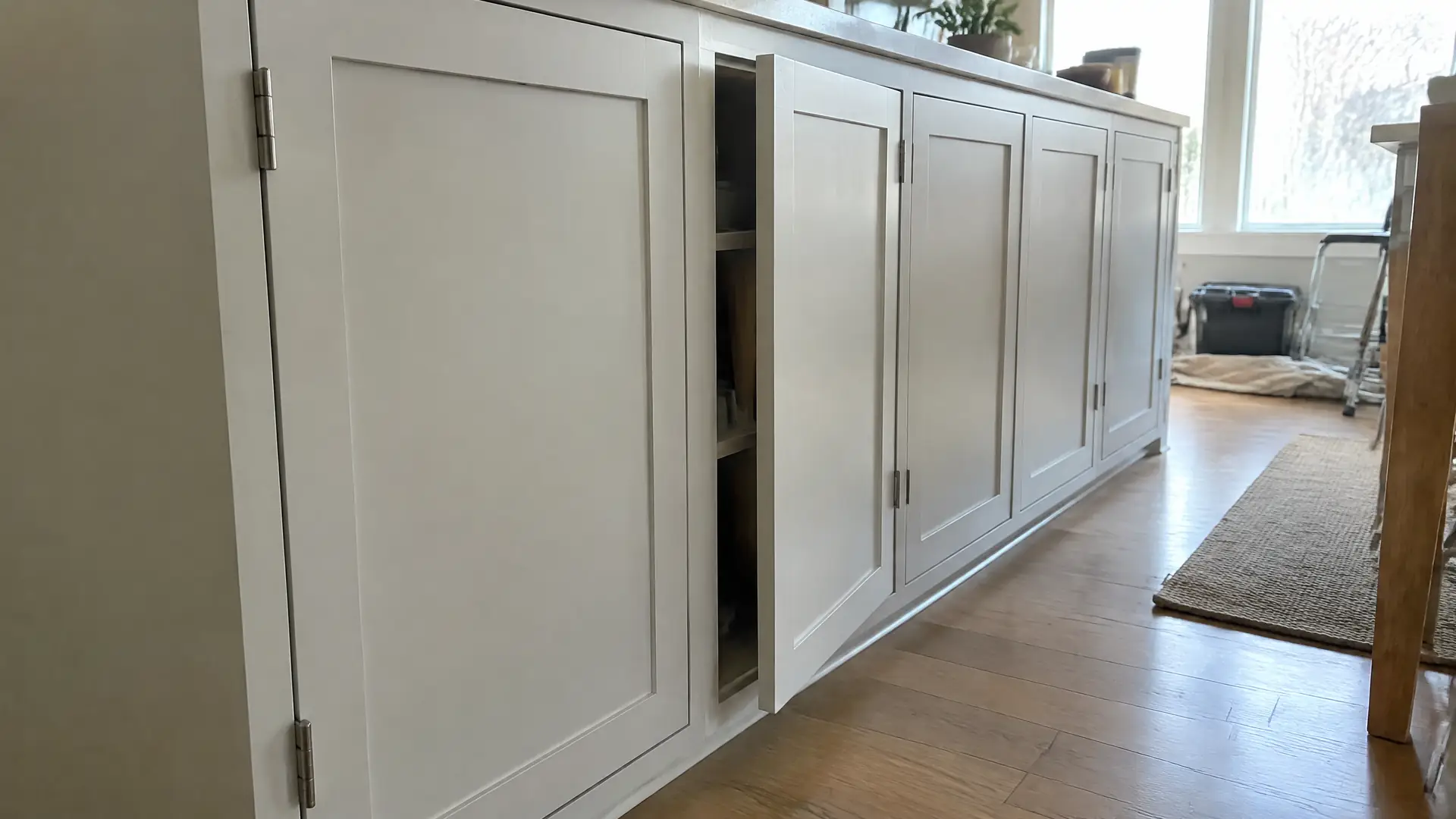 Inset cabinet doors set flush in painted face frames with an even reveal down the run