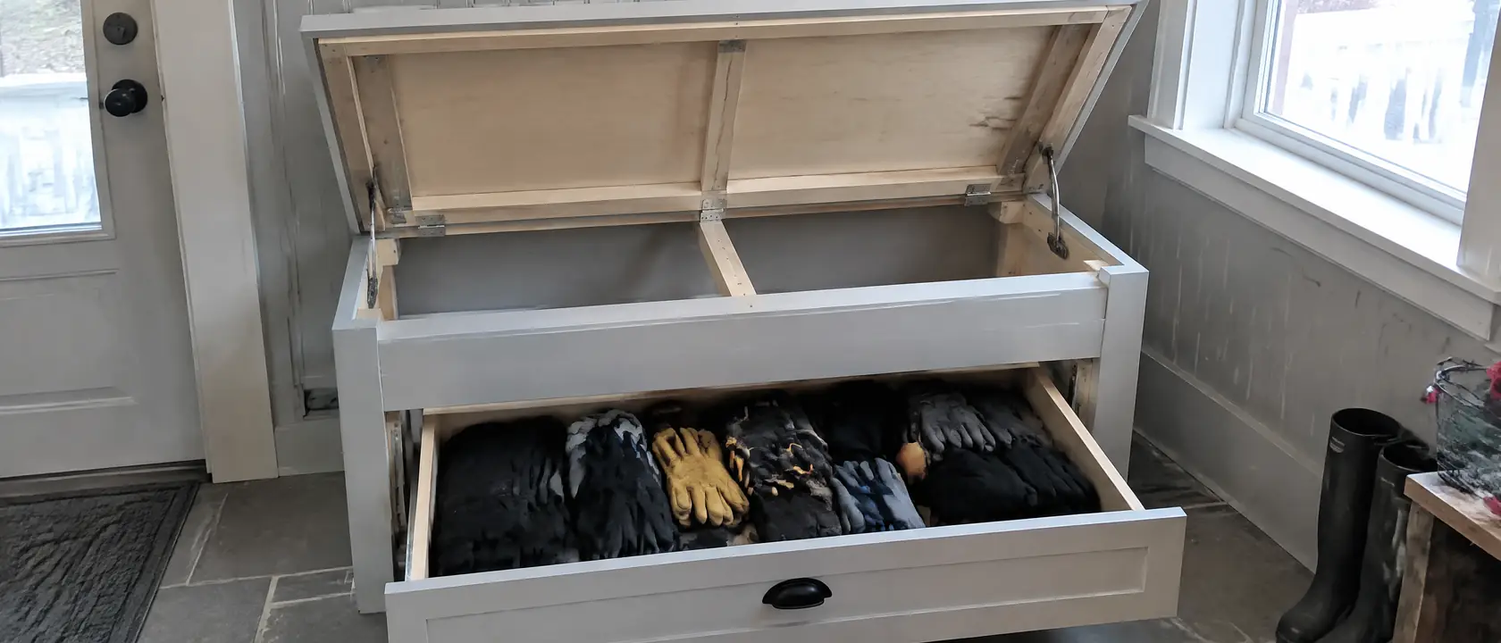 Mudroom bench with the lid propped open to show its internal frame, and a glove drawer pulled out on its slides