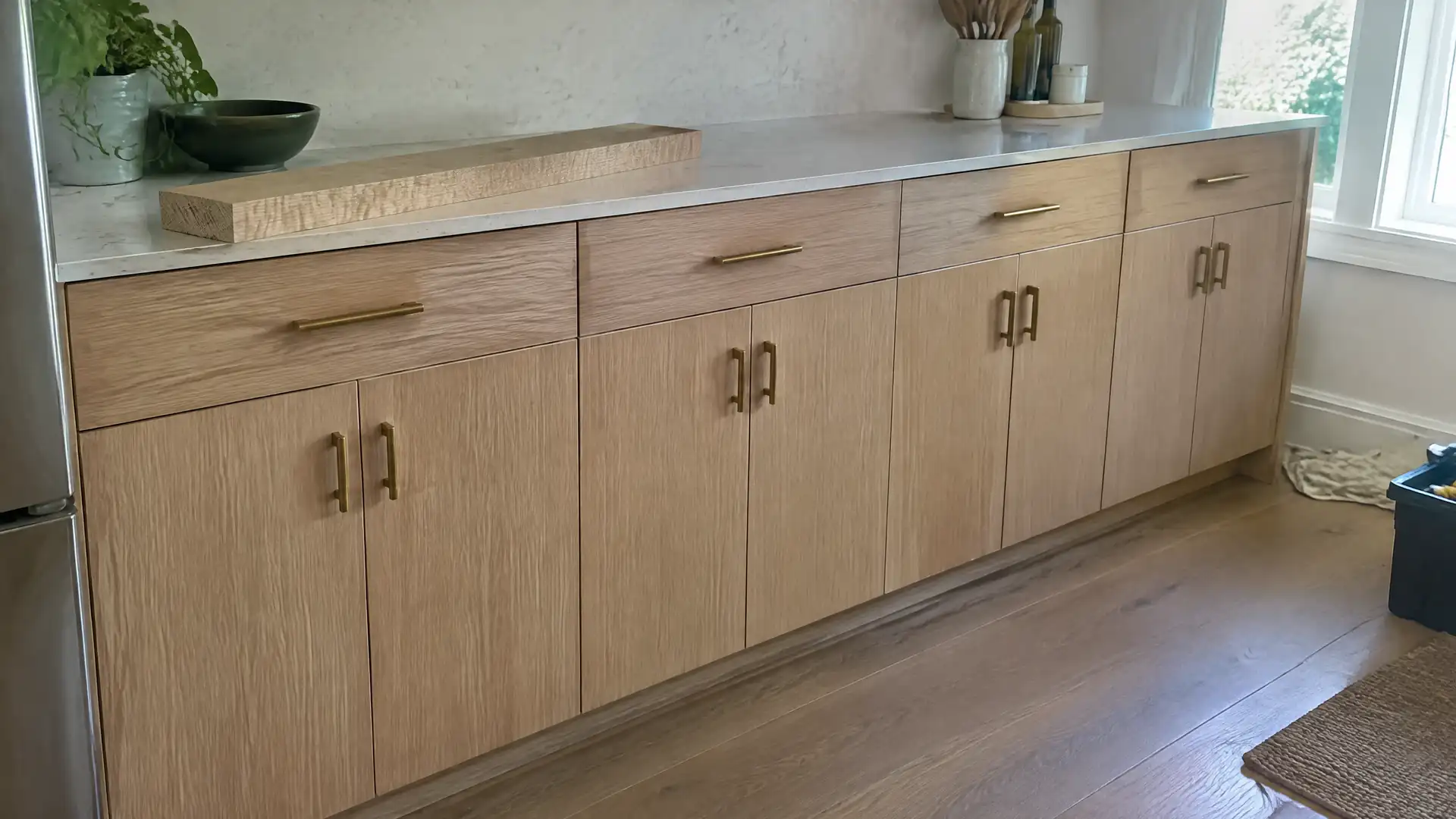 Rift-cut white oak fronts with the straight grain lined up across every door and drawer